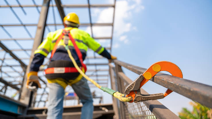 Construction workers wearing hard hats and high-visibility vests on site